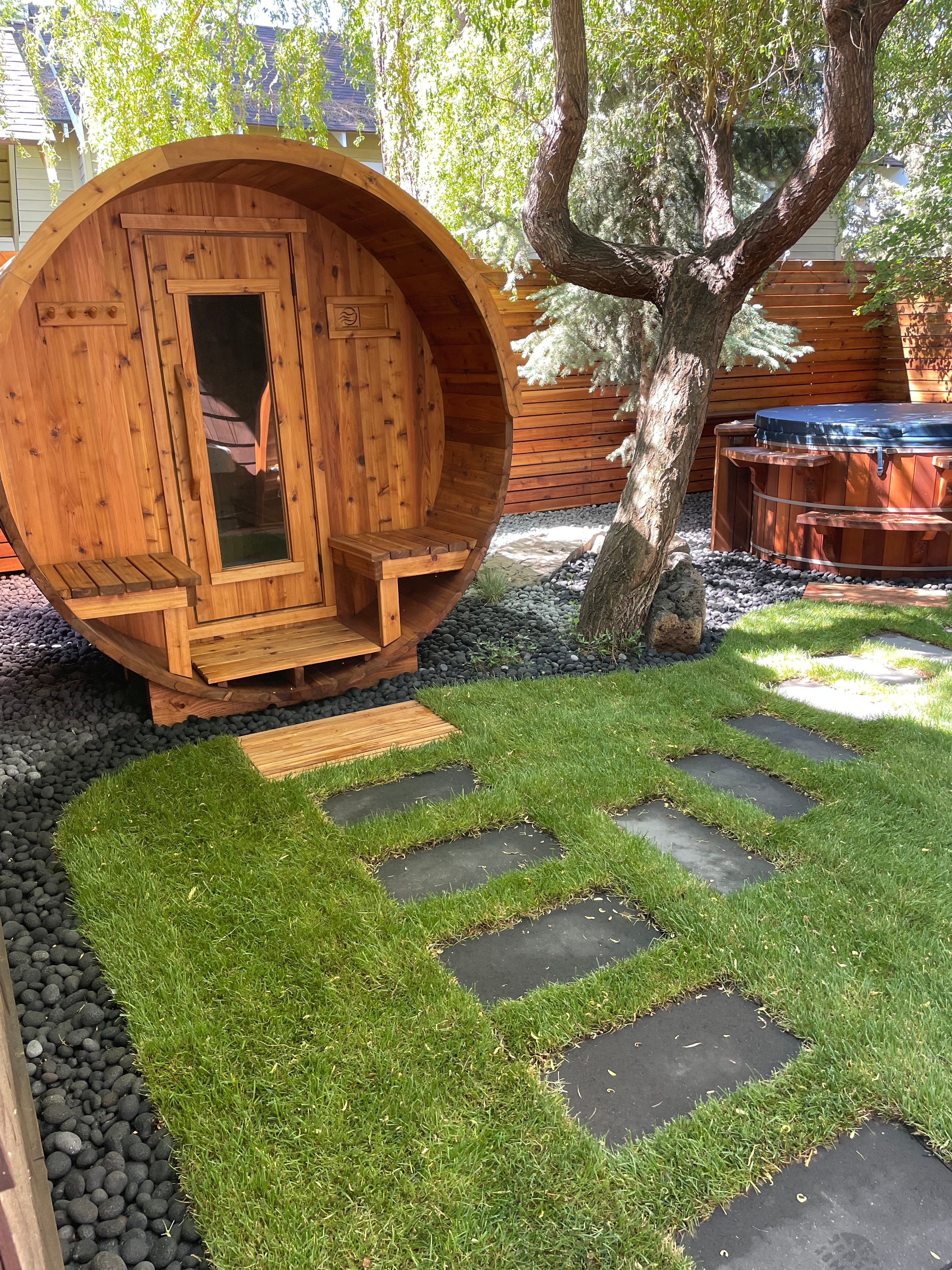 Cedar barrel sauna in a private backyard.