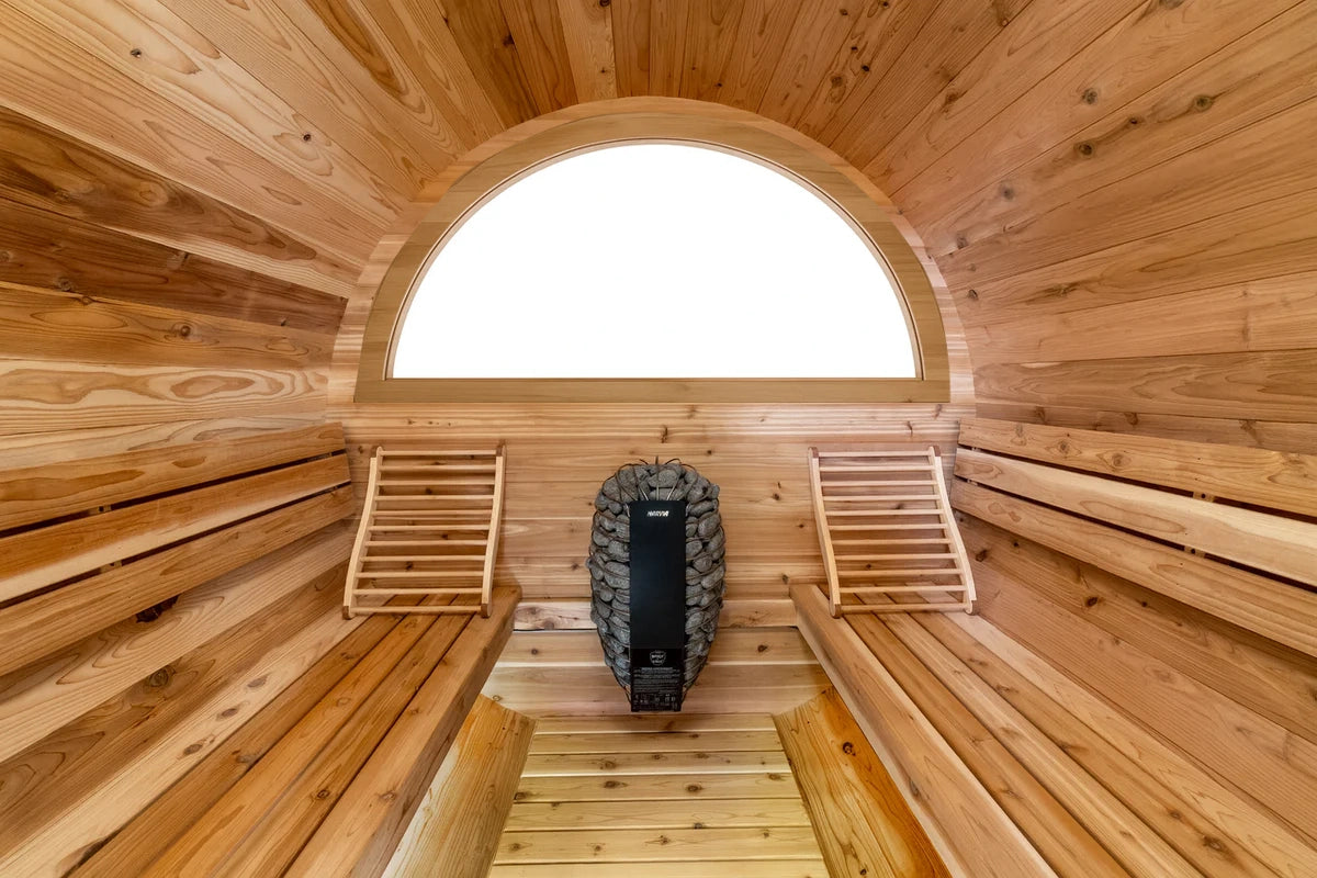 Wooden barrel sauna interior with curved half-moon window and benches